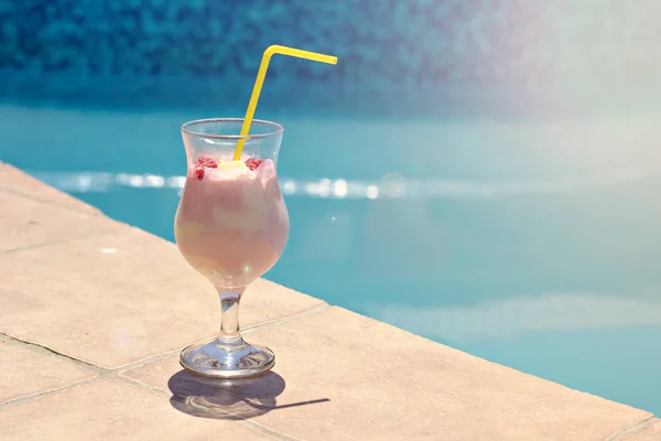 Summer cocktail on the background of the pool. Pina colada, milk cocktail, berry cocktail. Summer vacation, relaxation, summer party.