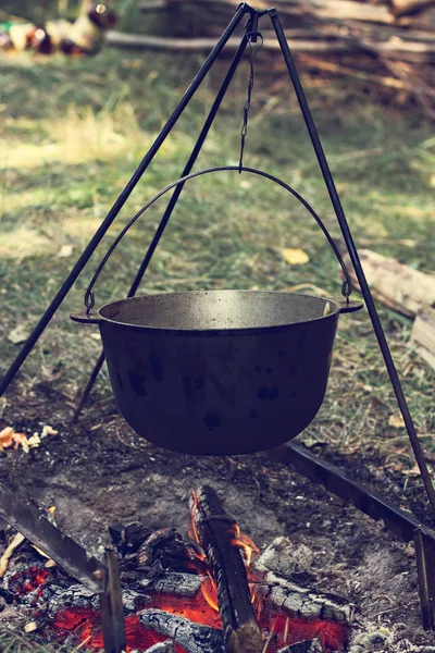 A pot of meat over a fire. Hike, summer vacation, outdoor recreation, outdoor food. Cooking over a campfire. tourist kettle over campfire.