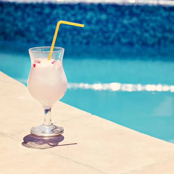 Summer cocktail on the background of the pool. Pina colada, milk cocktail, berry cocktail. Summer vacation, relaxation, summer party.