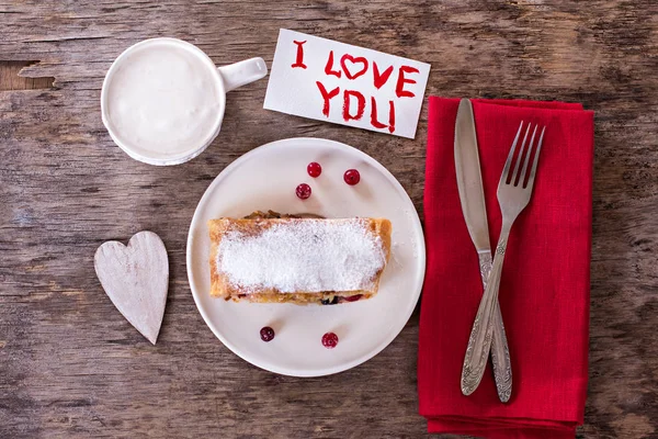 strudel and Valentine\'s Days decor. Strudel (pie) with  cranberries and powdered sugar with Valentine\'s Days decor. Rustic style. valentine, gift on Valentine\'s Day, Mothers Day, gift, surprise, heart