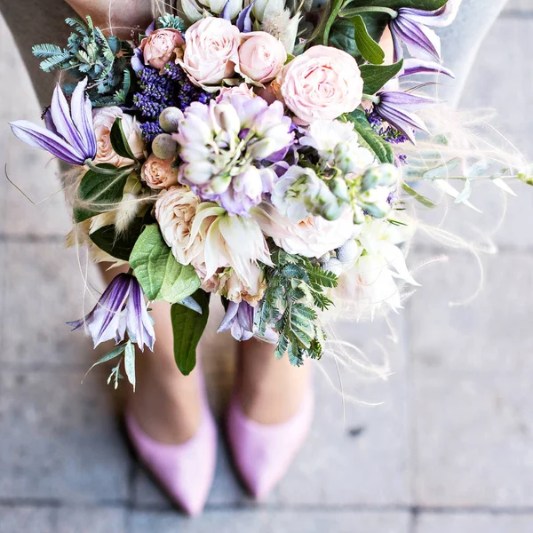 Beautiful bouquet with delicate flowers. Pink-white-purple bouquet. Bridal bouquet in female hands. Beautiful bouquet with delicate flowers. Pink-white-purple bouquet. Bridal bouquet in female hands