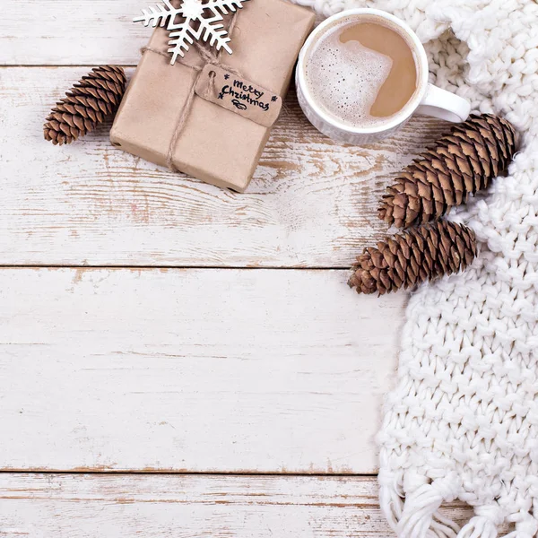 Gift, cones, gifts, coffee, cocoa. Christmas, New Year background.   A woman\'s hand holds a cup. Winter, New Year, Christmas still life.