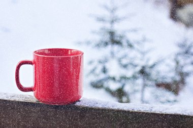 Kahve bardağı, çay kış manzara arka plan üzerinde. Kış orman bir fincan sıcak bir içecek arka planda ile. Masanın içinde belgili tanımlık kış açık. Kış zaman kavramı.