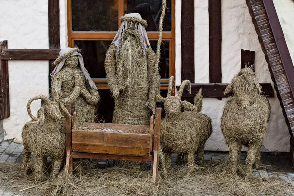 Christmas Manger scene with straw figurines including Jesus, Mary, Joseph, sheep and magi. Christmas nativity scene with figurines made of straw