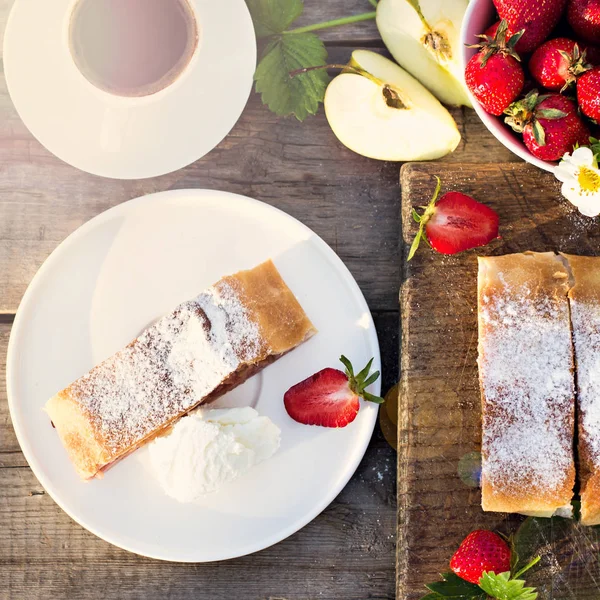 Apple and Strawberry Strudel.   Pie with apples and strawberries, summer pie. Summer breakfast in nature.