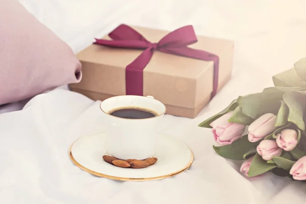 Bouquet of flowers - tulips, gift and coffee.