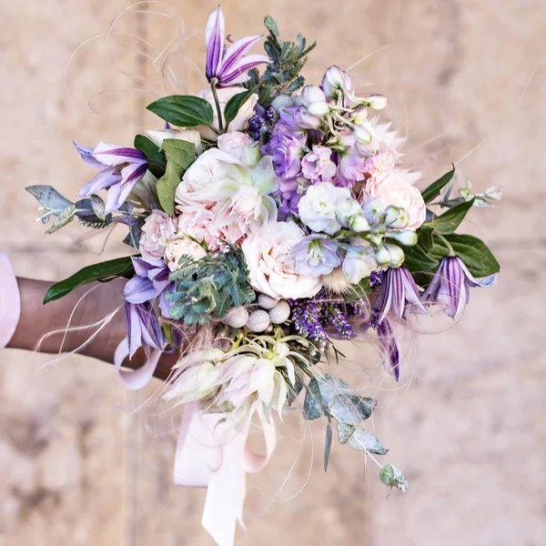 Beautiful bouquet with delicate flowers. Pink-white-purple bouquet. Bridal bouquet in female hands — Stock Photo, Image