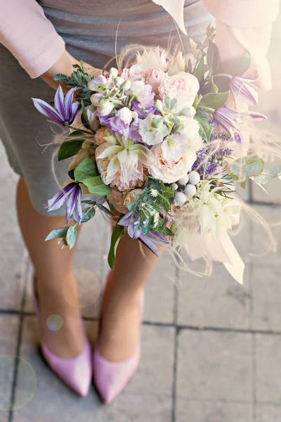 Beautiful bouquet with delicate flowers. Pink-white-purple bouquet. Bridal bouquet in female hands