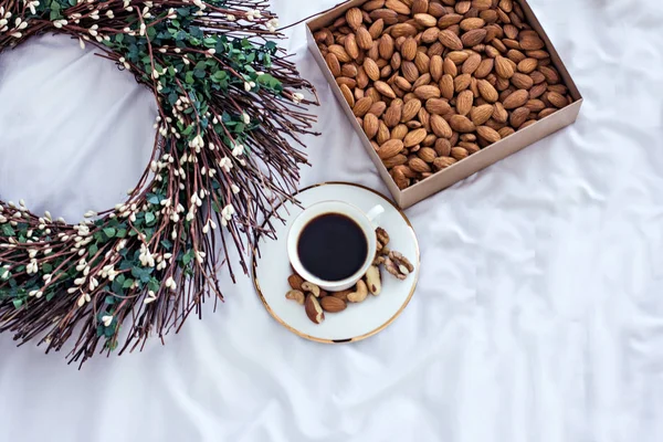 coffee in bed, nuts and spring wreath