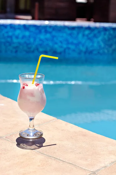 Summer cocktail on the background of the pool. Pina colada, milk cocktail, berry cocktail.