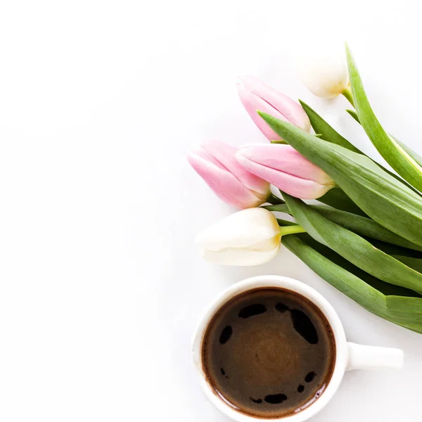 Espresso coffee cup and tulips on white background