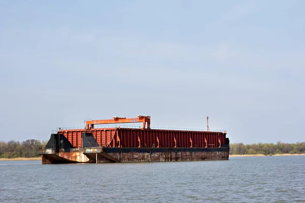 Barge, a large cargo ship on the river.