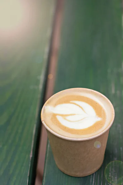 Café capuchino en taza de papel sobre la mesa vieja de madera —  Fotos de Stock