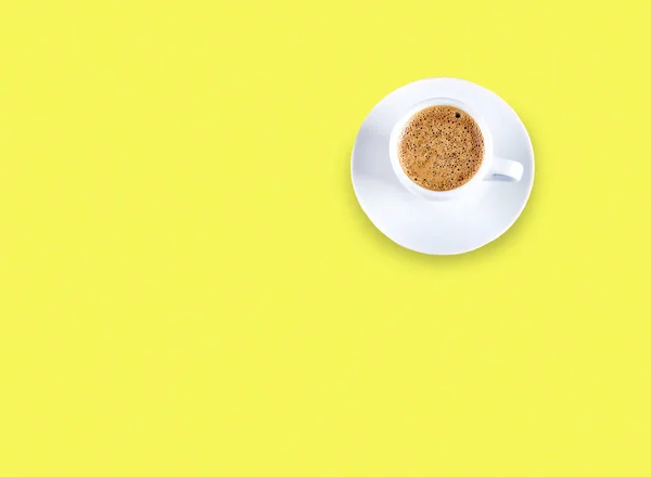 Cardboard cup of coffee on  neon background, copy space, top view