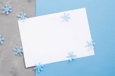 Mavi renkli dekoratif kar taneleri ile minimalist Noel kartı mockup. Boş Kartpostal. Xmas arka plan, kopya alanı ile üstten görünüm.