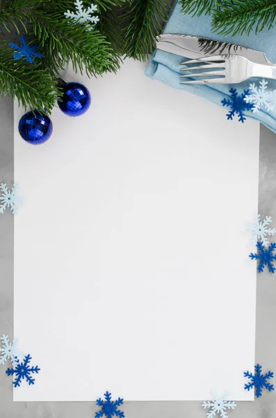 Background for writing the Christmas Menu. Winter Table Setting. Christmas tree, cutlery and blank paper. Top View, Copy Space.