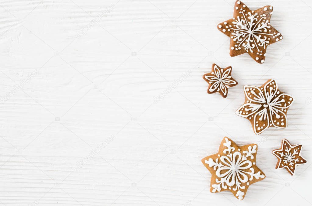 Christmas homemade gingerbread cookies on the white wooden background. Flat lay. Copy Space.
