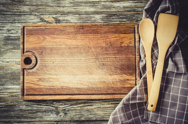 Culinary background with rustic kitchenware on vintage wooden table.