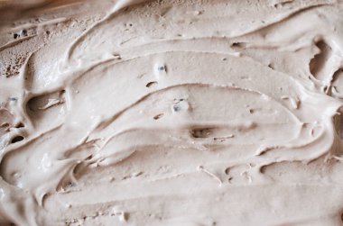 Çikolata dondurması eritme dokusu. Kahverengi arka plan.