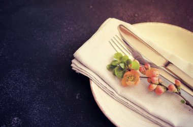 Koyu bir arka plan üzerinde narin çiçekler ile Vintage masa ayarı