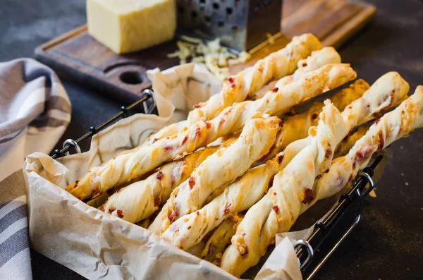 Cheese stick. Breadsticks with cheese on dark background. Concept for snack or party time