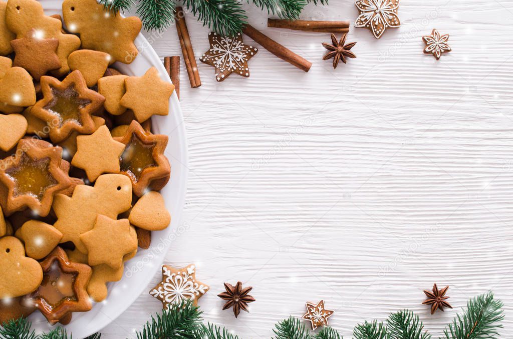 Culinary background with freshly baked Christmas gingerbread, spices and fir branches. Copy space