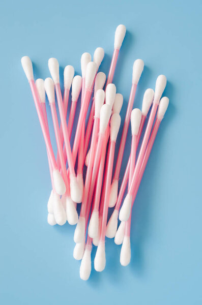 Cosmetic cotton buds on blue background. Sticks for cleaning ears.