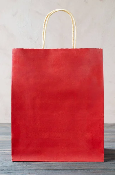 Mock-up of blank craft package, mockup of red paper shopping bag. Copy space for your logo. Holiday shopping. Christmas presents