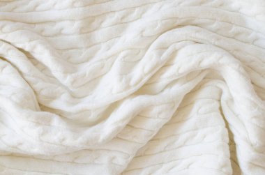 Bej örülmüş yün arka plan. Örgü kumaş dokusu. Kopya alanı ve üst görünümü olan İskandinav minimalizmi