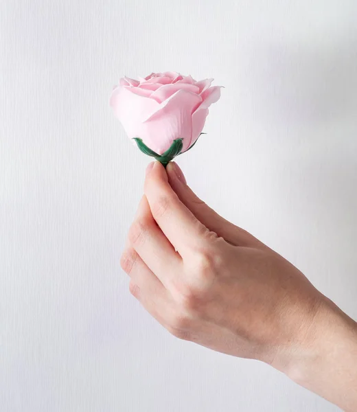 Artificial flower handmade: Rose bud in hand.