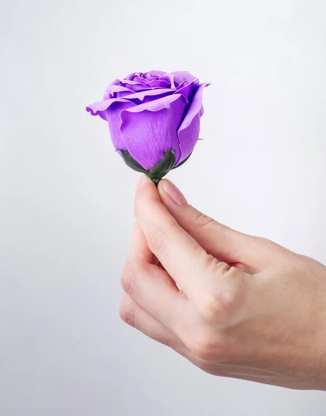 Artificial flower handmade: Rose bud in hand.