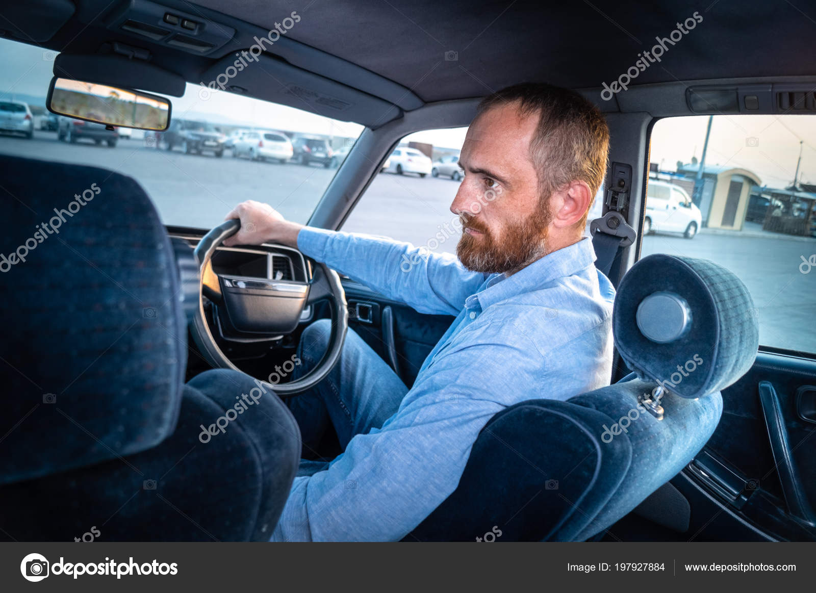Man Red Beard Blue Shirt Driving Car Parking Lot Blue