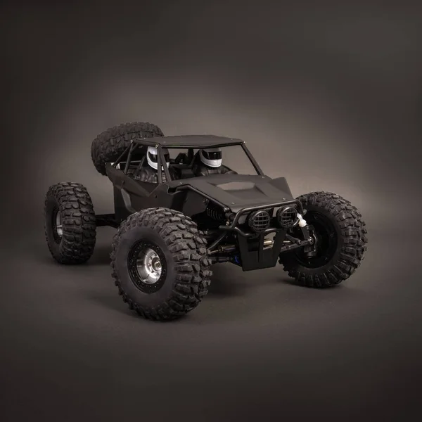 Radio-controlled car models: a little black buggy on a dark gray background. — Stock Photo, Image