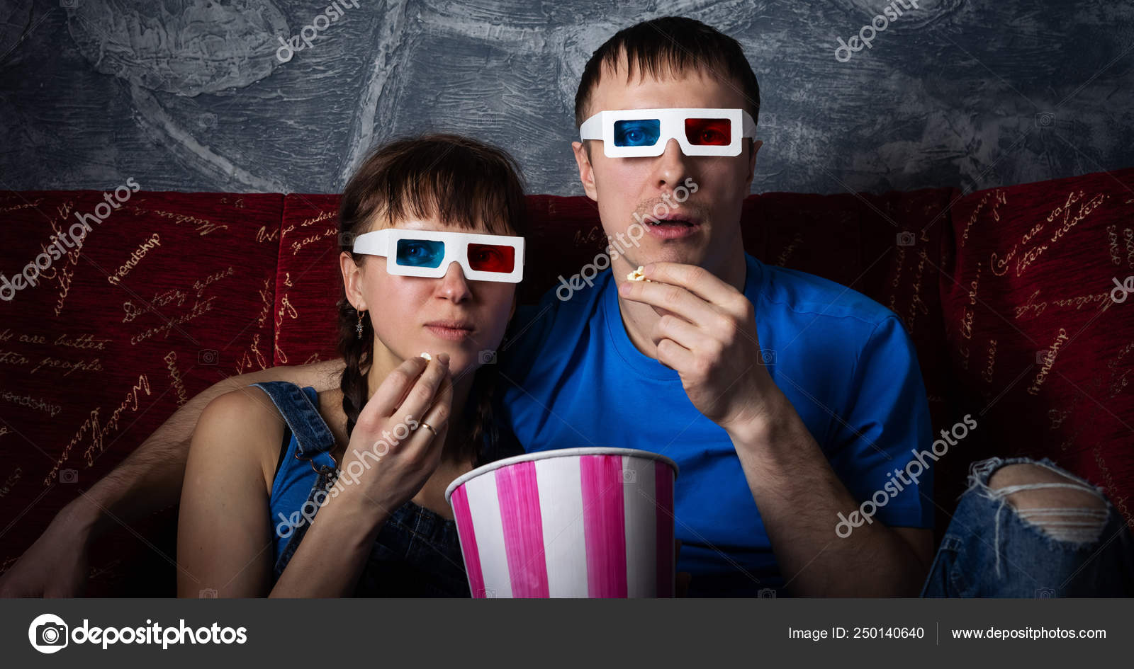 A Couple Of Guy And Girl Are Watching A 3d Movie With Glasses At Home On A Red Sofa Stock Photo C Duh84 250140640