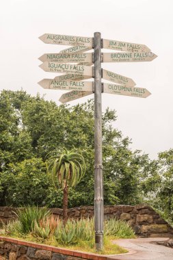 A signpost, showing the distances to famous waterfall of the world, at the Howick Falls, in Howick, in the Kwazulu-Natal Midlands Meander clipart