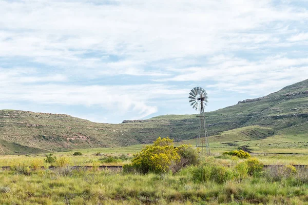 A landscape with a water-pumping windmill and the historic railway track between Lady Grey and Barkly East in the Eastern Cape Province