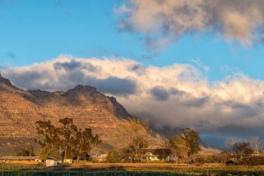 Kromrivier, Güney Afrika, 25 Ağustos 2018: Sunrise Kromrivier Cederberg Park, bir tatil Cederberg dağlarda. Tarihi su değirmeni sol tarafta görünür