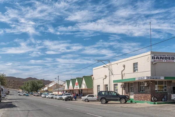 WILLISTON, SOUTH AFRICA, AUGUST 31, 2018: A street scene, with vehicles, people and businesses, in Williston in the Northern Cape Province
