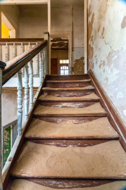 Luderitz yakınlarında terk edilmiş bir elmas madencilik kasabası olan Kolmanskop 'ta harabe halinde bir merdiven.
