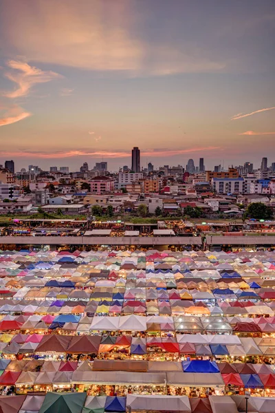 Market with colorful tents in sunset time. This is place in Thailand call Train Market