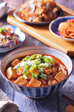  Rustik ahşap bir masada mapo doufu ile pirinç bir kase 