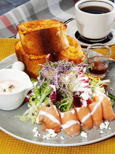 Breakfast of french toast with smoked salmon and salad