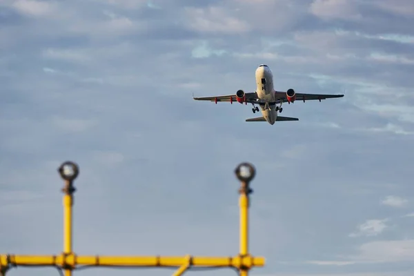 Traffic at the airport. Low angle view of the airplane during take off over landing lights.