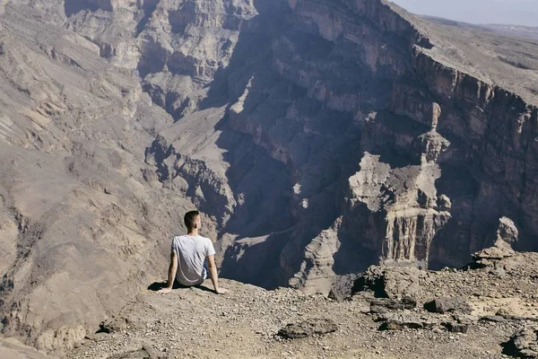 年轻的游客休息在悬崖边 Jebel Akhdar 阿曼大峡谷 — 图库照片