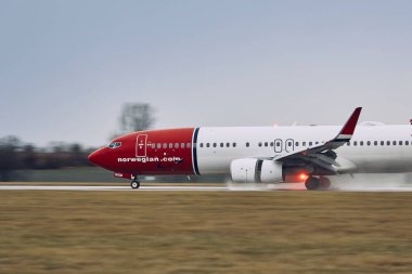 Prague, Czech Republic - December 11, 2018: Norwegian Boeing 737-800 during landing in rain at Prague Airport on December 11, 2018. clipart