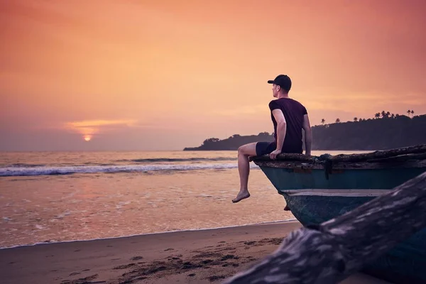 Young Man Sitting Fishing Boat Sunrise Contemplation Idyllic Sand Beach — Stock Photo, Image
