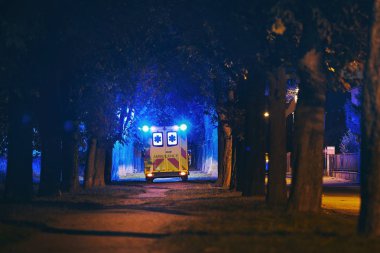 Emergency ambulance in dark alley clipart