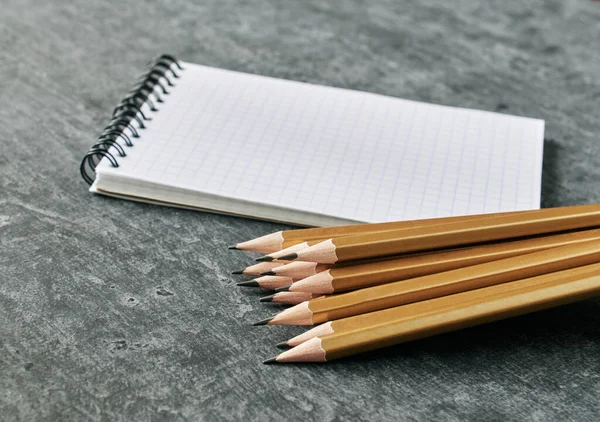 Notebook Stack Simple Golden Colored Pencils Gray Background Shallow Depth — Stock Photo, Image