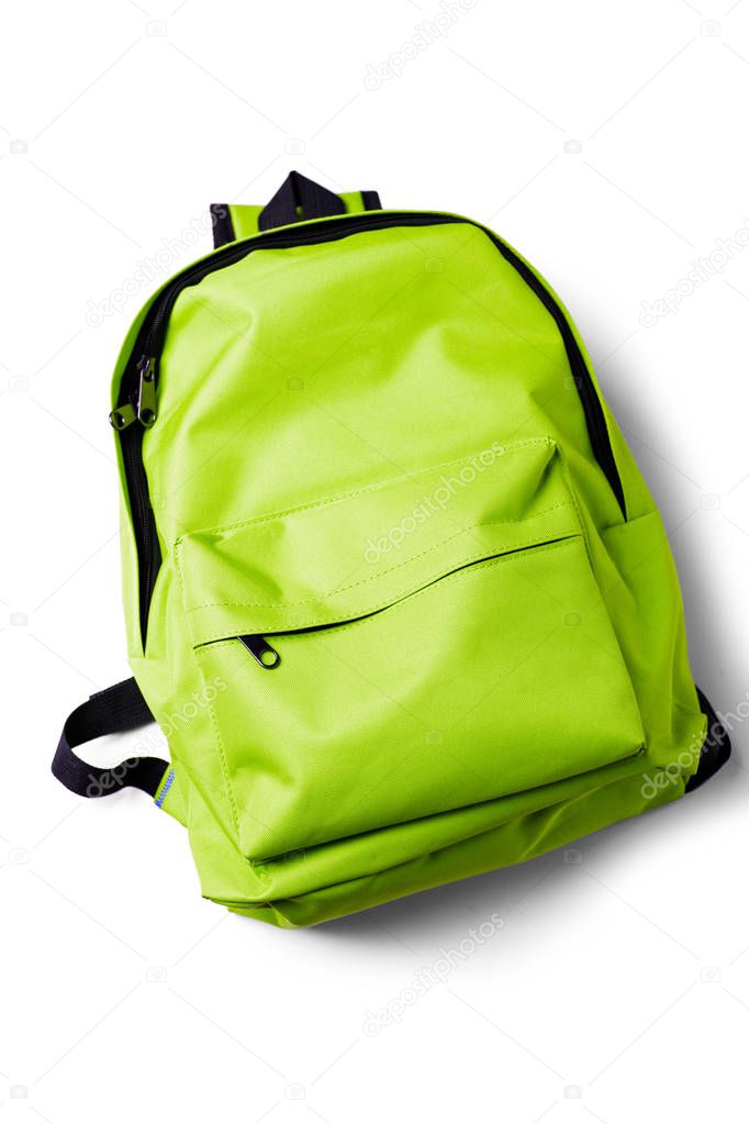 Top view of green school backpack on white background