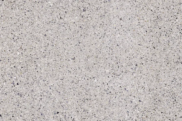 Granit mozaik desen, beton zemin arka planı. Beton dokusunda beyaz granit taşlar var.